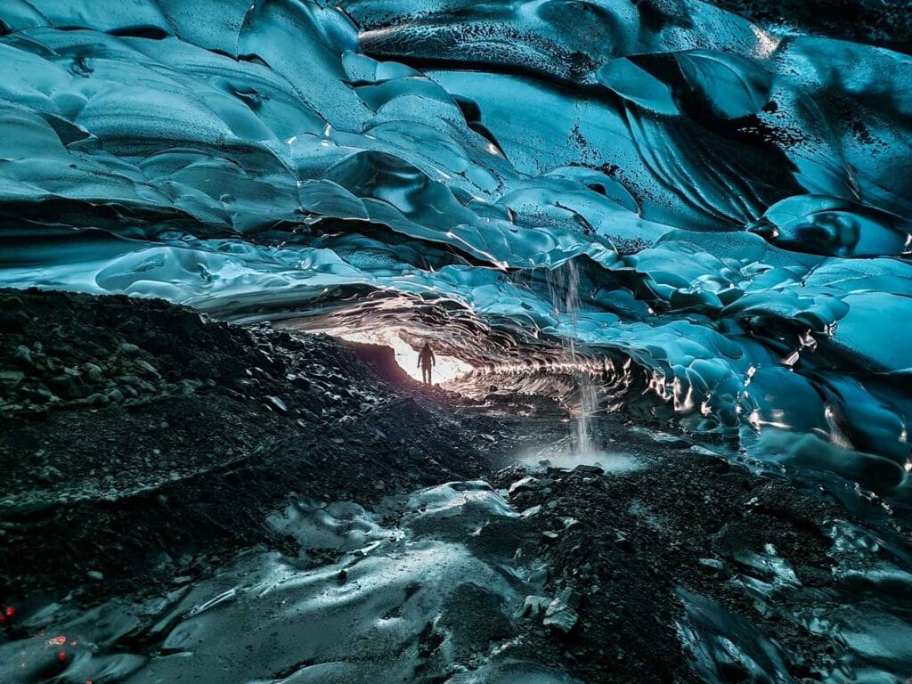 Stunning blue ice cave with silhouette