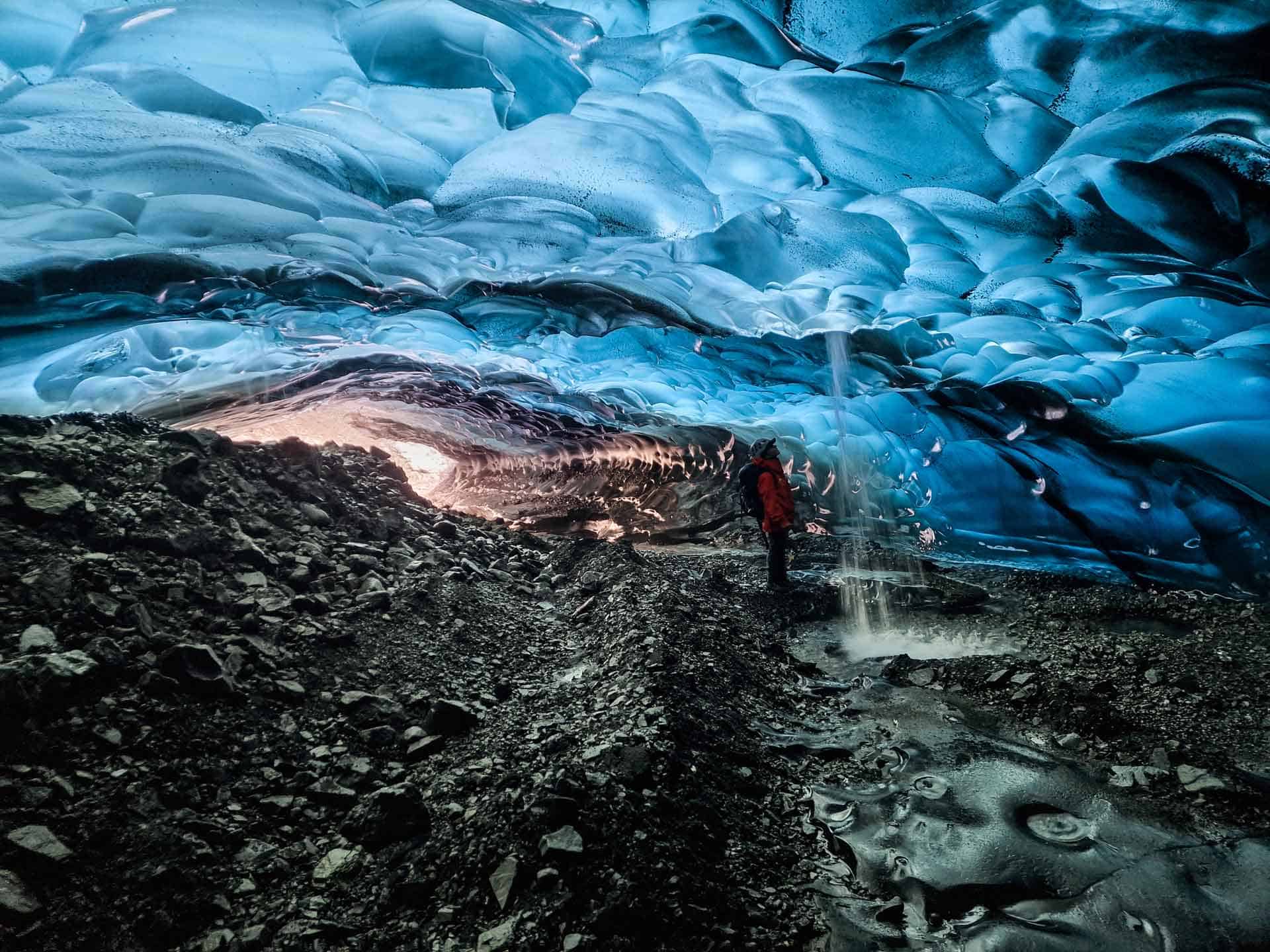 Stunning blue ice cave with explorer, ABC Ice Cave,