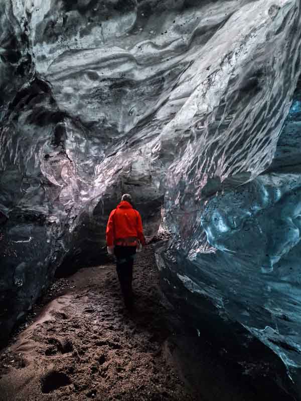 Person walking through ice cave