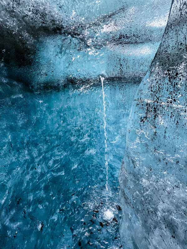 Glacial ice cave with blue hues.