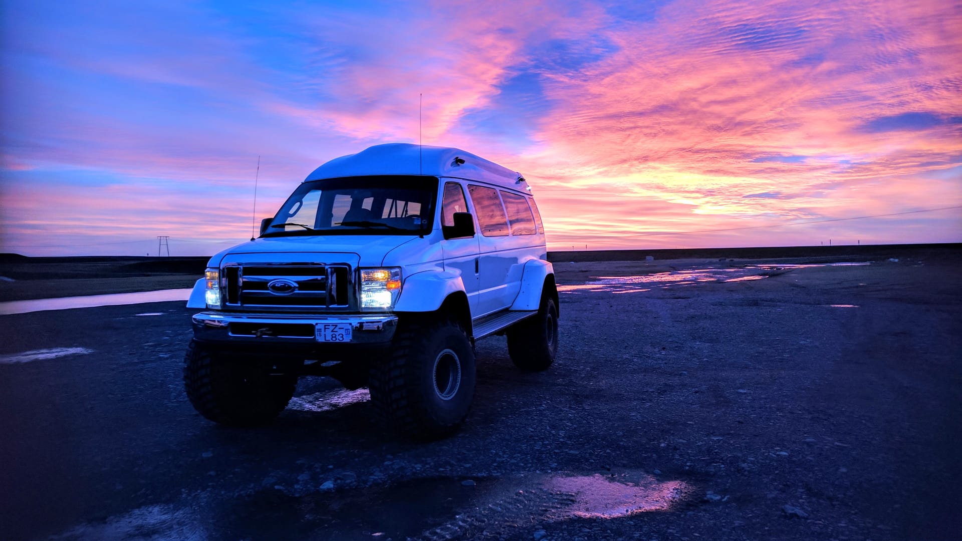 Glacier Trips Super Jeep under a pink summer sunset in southeast Iceland